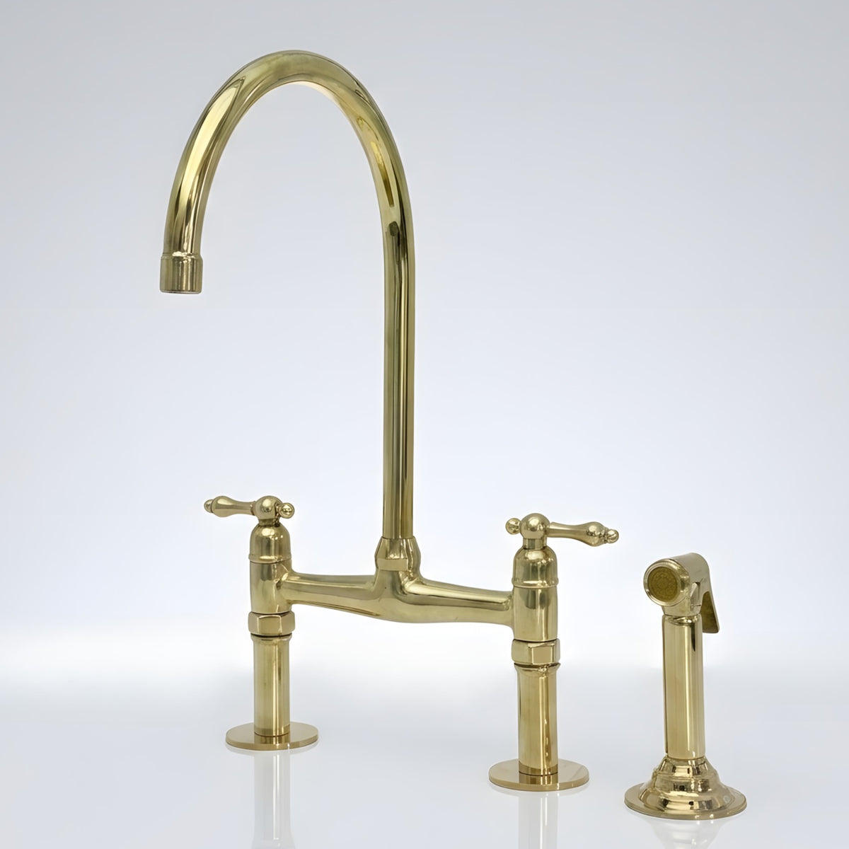 Unlacquered brass bridge kitchen faucet with side sprayer and Finial lever handles