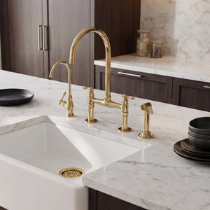 Detail of the Finial lever handles on the unlacquered brass bridge kitchen faucet