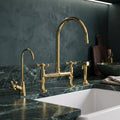 Unlacquered brass bridge kitchen faucet with Petal cross handles, side sprayer and drinking water tap