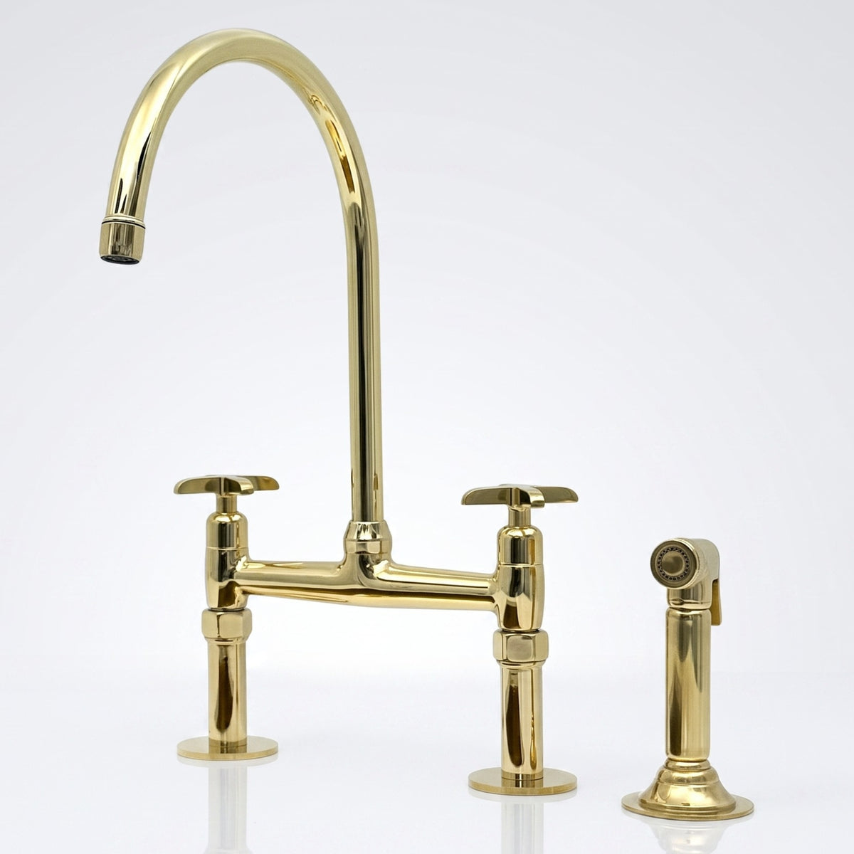 Unlacquered brass bridge kitchen faucet with side sprayer and Blade cross handles